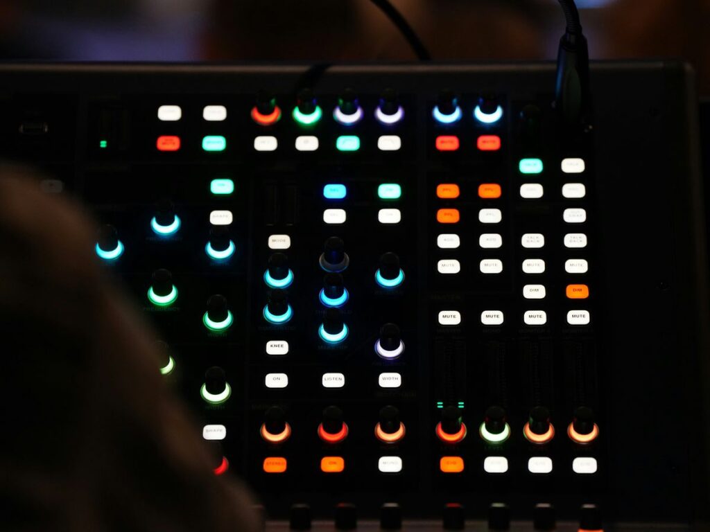 a close up of a sound board in a dark room